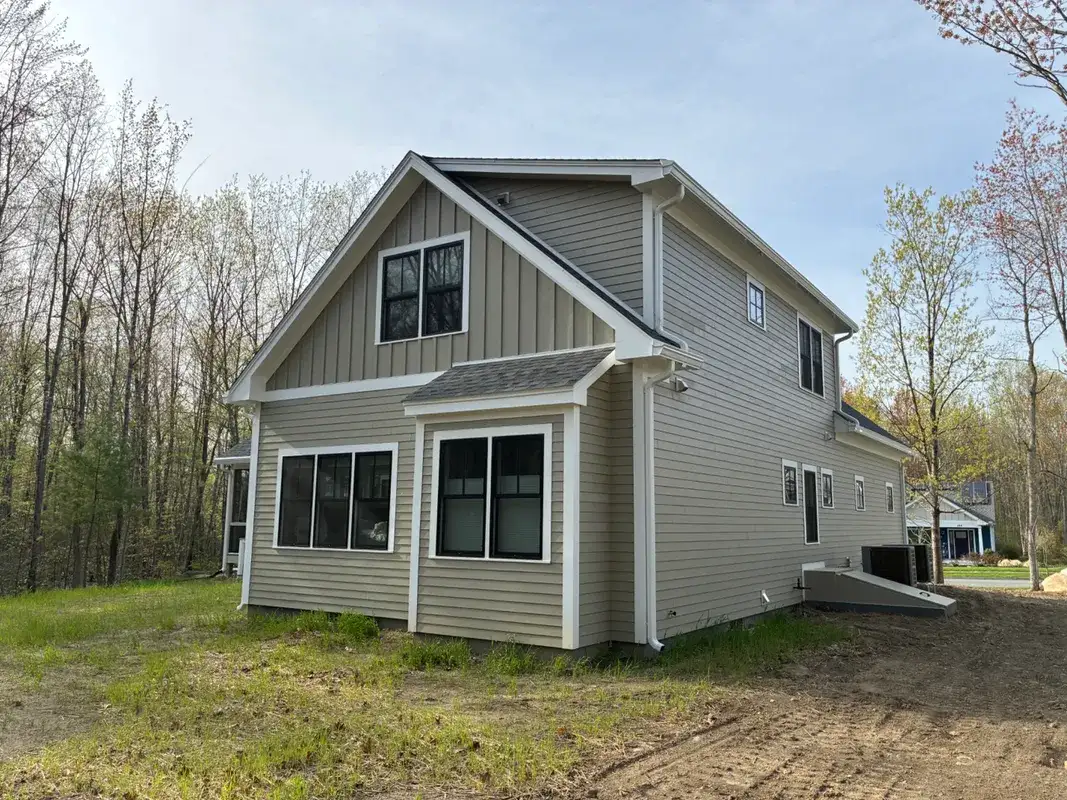 New gray siding and white trim on a modern residential home.