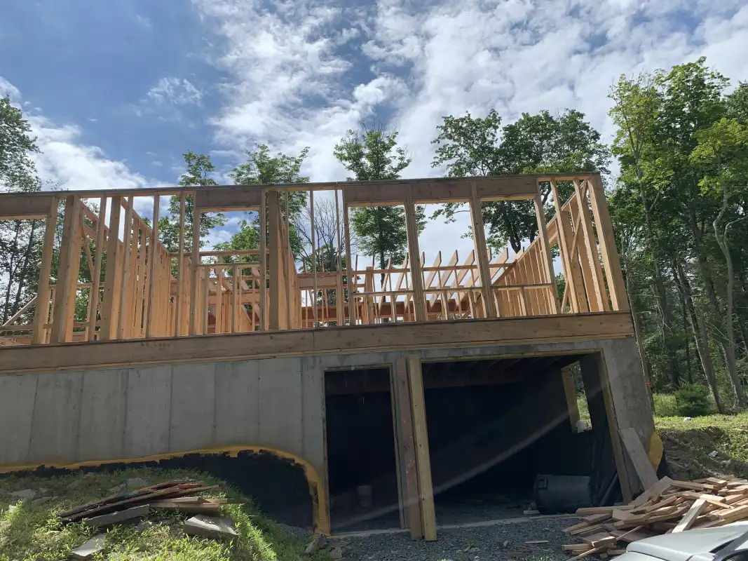 house-under-construction-green-siding-before.webp